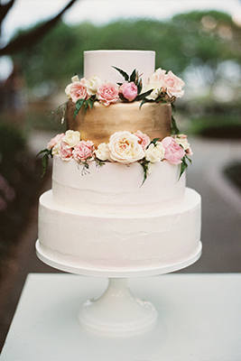 White buttercream wedding cake with metallic gold layer and floral accent in Dallas, Texas by After Yes