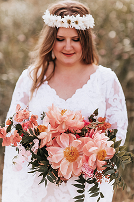 Wedding day bridal portrait with daisy chain headpiece, a bouquet with shades of pink and custom Patti Flowers gown at Trinity River Audubon Center in Dallas, Texas by After Yes